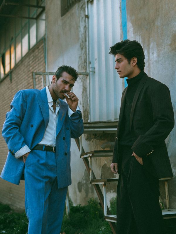 A man in a tailored blue suit
